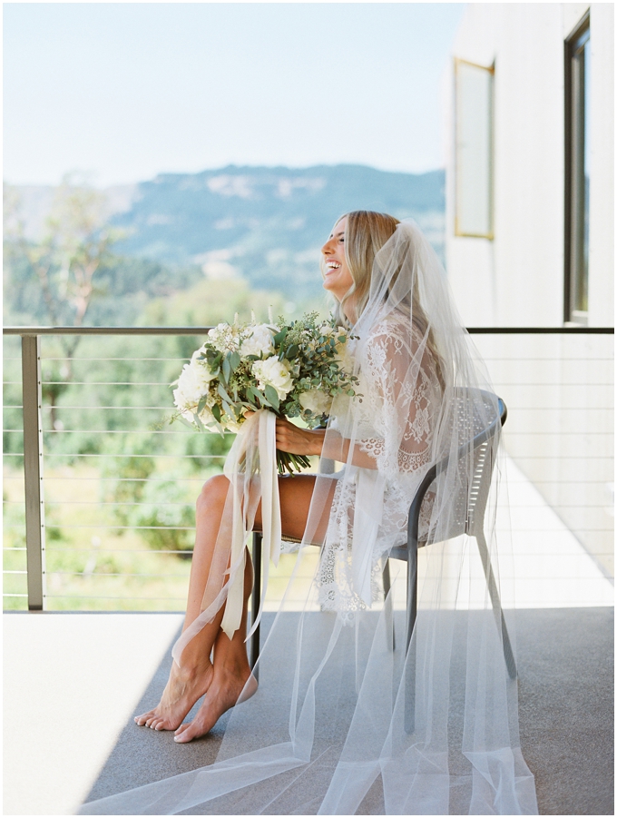 bride on her wedding morning wearing veil and holding bouquet
